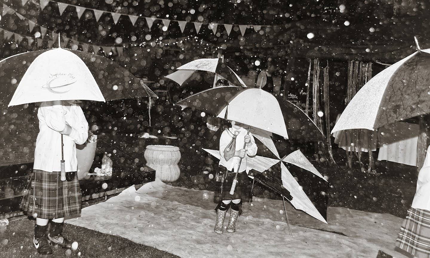 Children with umbrellas by Edinburgh Wedding Photographer Ewan Mathers